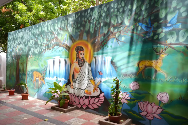 Side view of the Sudar Hospital building with wall murals